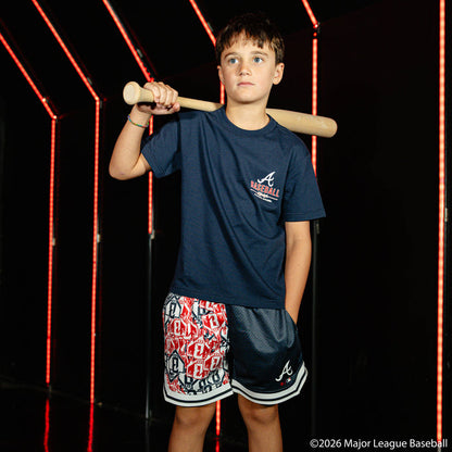 Youth model wearing navy youth shorts with "Atlanta Braves Sticker Court" design